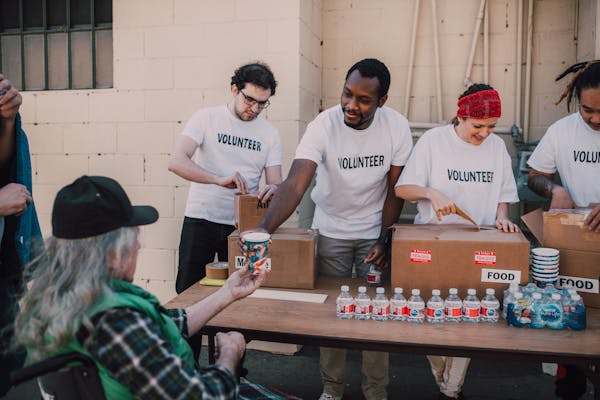 Volunteers distribute food at a charity event